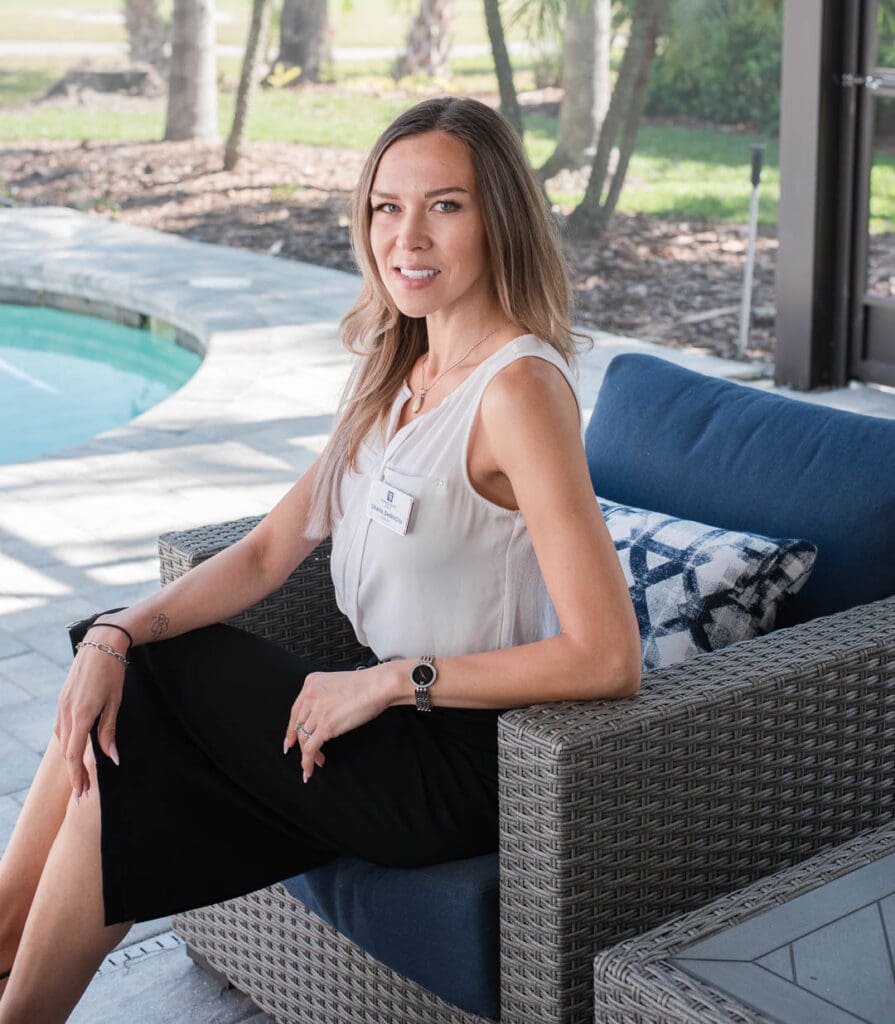 brand photo of woman sitting on chair in lanai